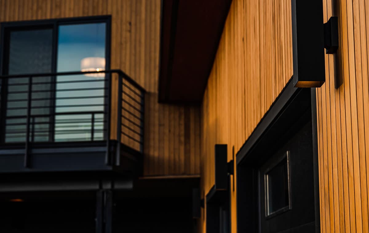 Custom home exterior with a mix of siding materials and light fixtures