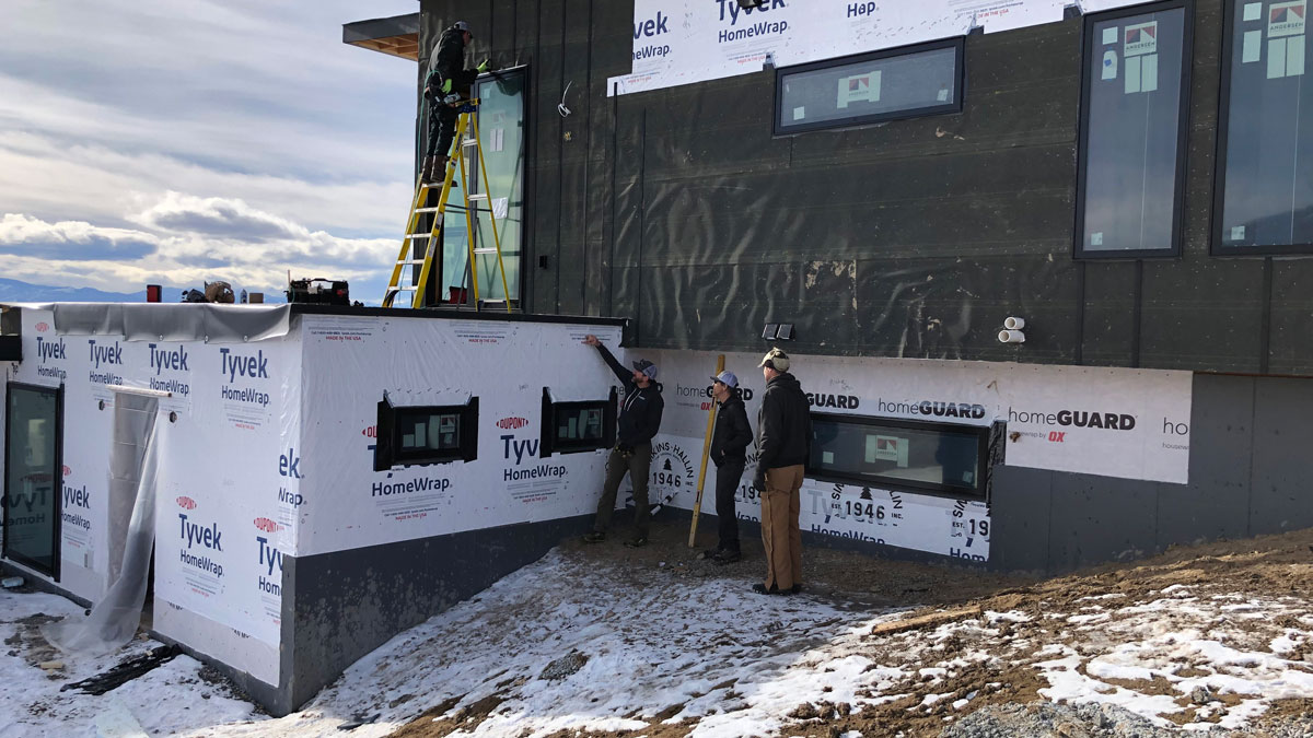 Construction crew working on a custom home exterior