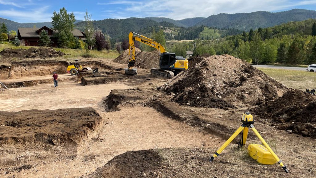 A building lot being prepped for excavation with construction equipment